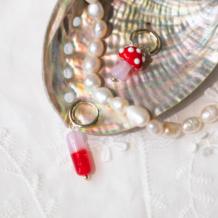 Red capsule and mushroom earrings